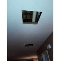 A minimum amount of holes cut in the ceiling in order to gain access to the full vent line which must be replaced.